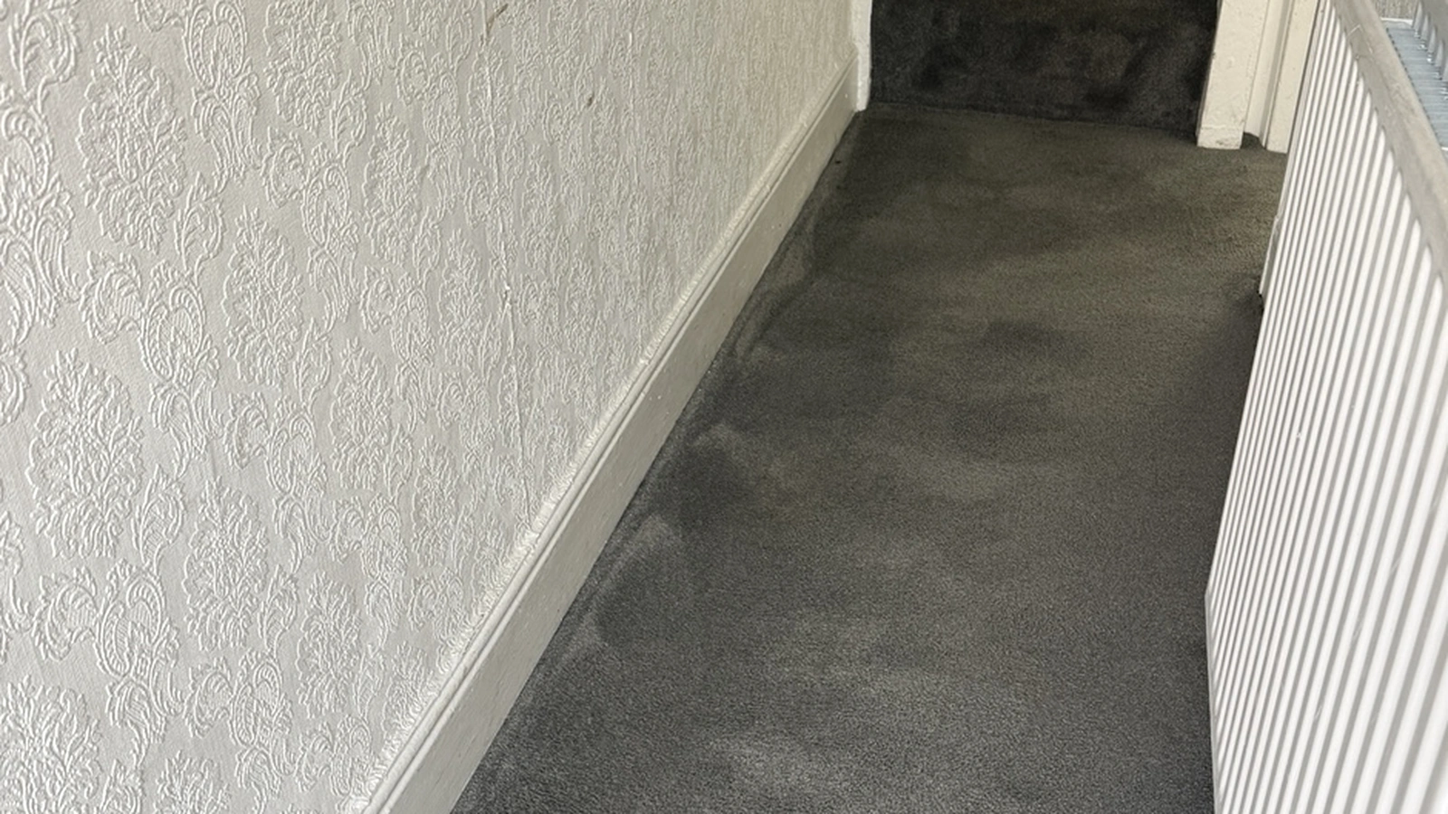 Rental property carpet restored using low-moisture deep cleaning after heavy tenant soiling