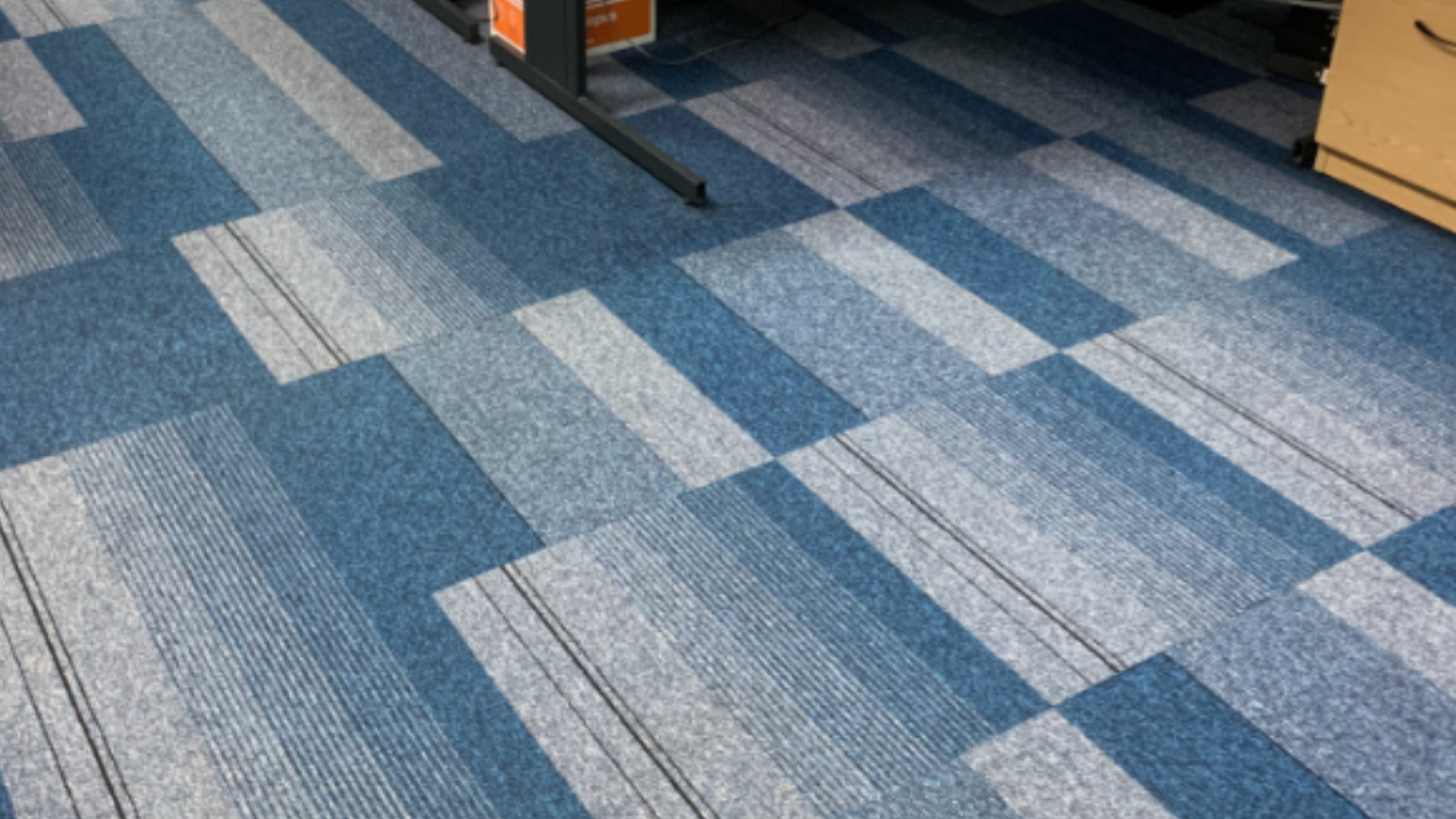 Office carpet tiles in a North East business after annual low-moisture maintenance cleaning restored a brighter appearance