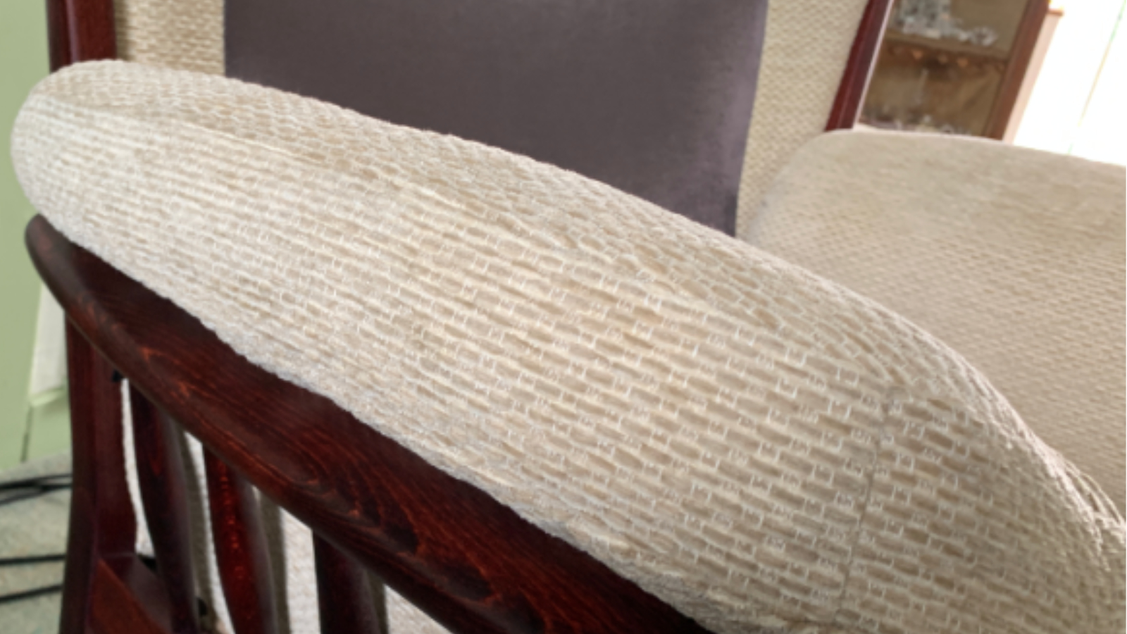 Fabric sofa arm restored after degreasing and low-moisture upholstery cleaning in Durham