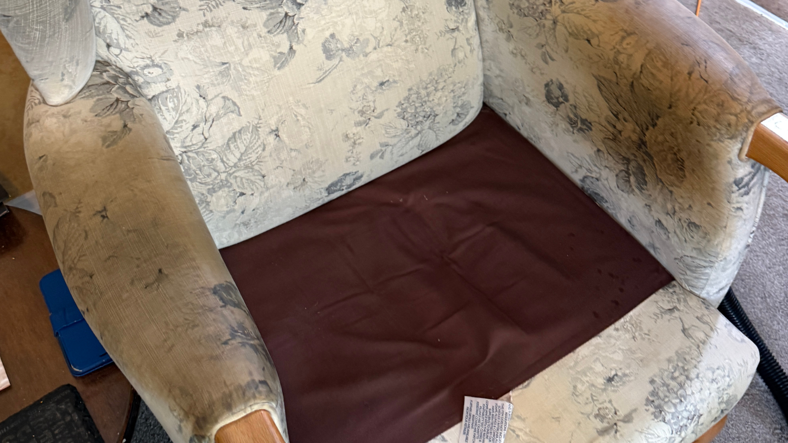 Heavily stained fabric armchair before upholstery cleaning and sanitisation in Durham