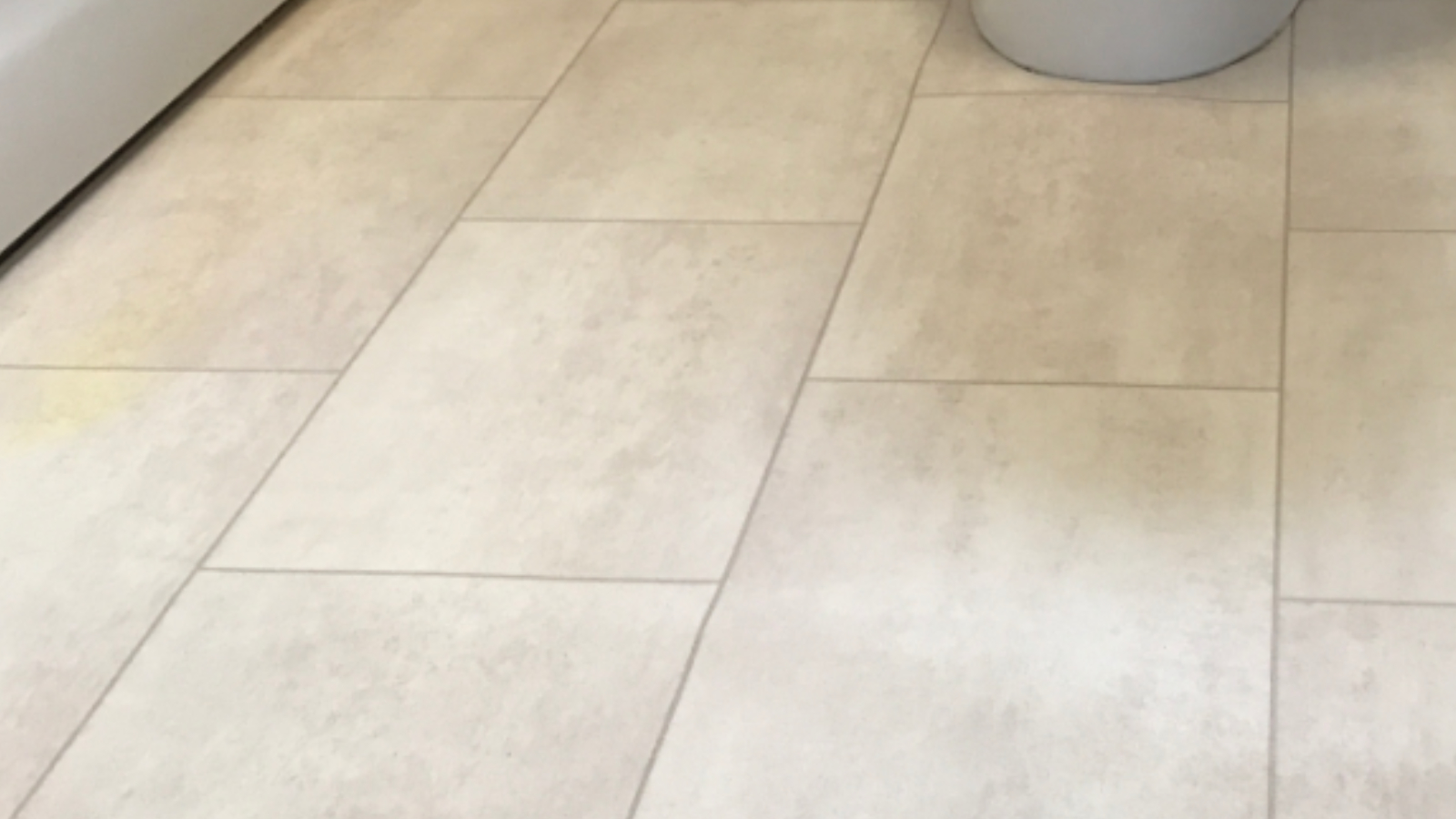 Bathroom vinyl floor in Washington after professional deep cleaning restored a brighter cleaner appearance