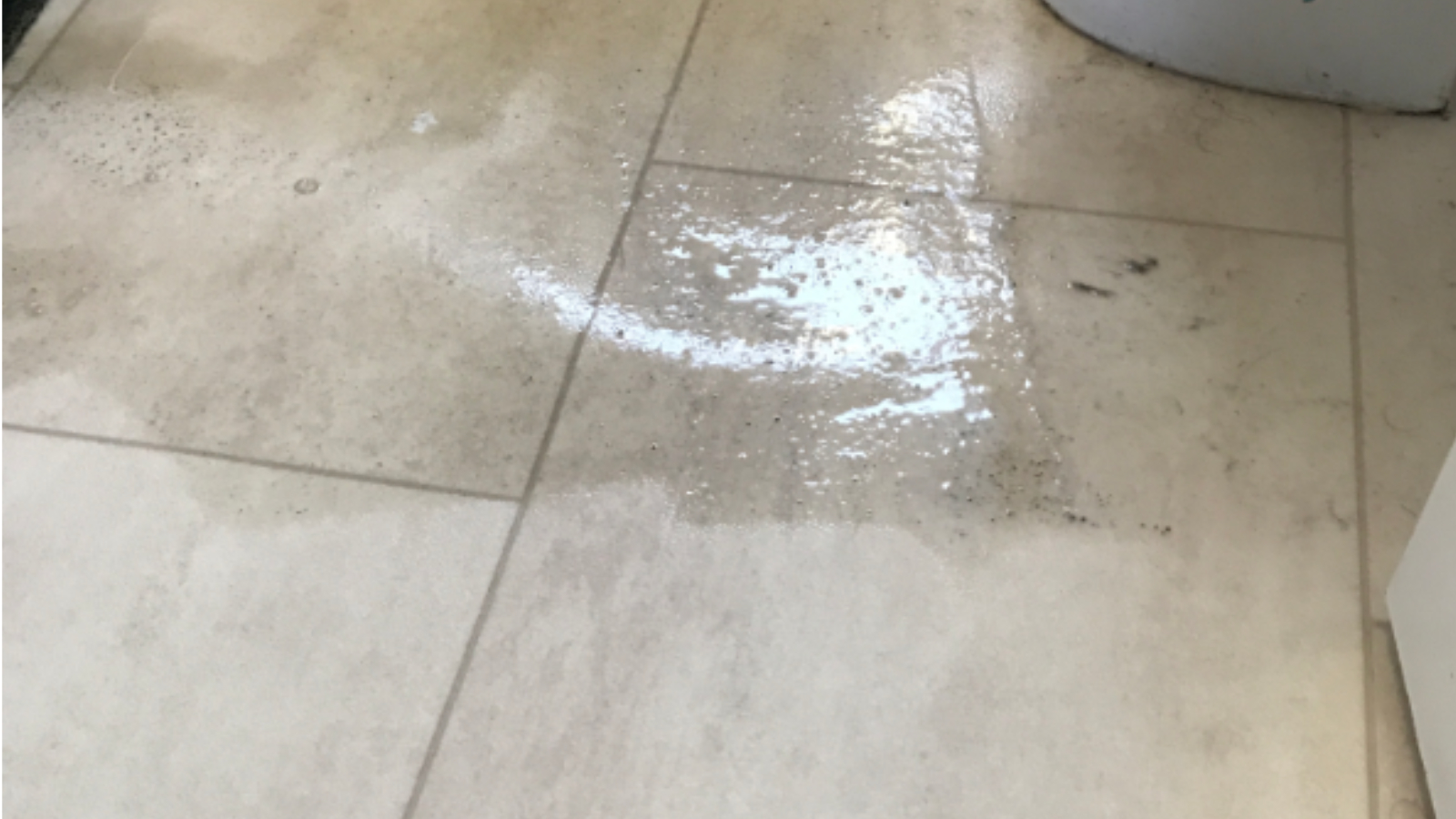 Bathroom vinyl floor in Washington before professional deep cleaning showing dull residue and embedded dirt