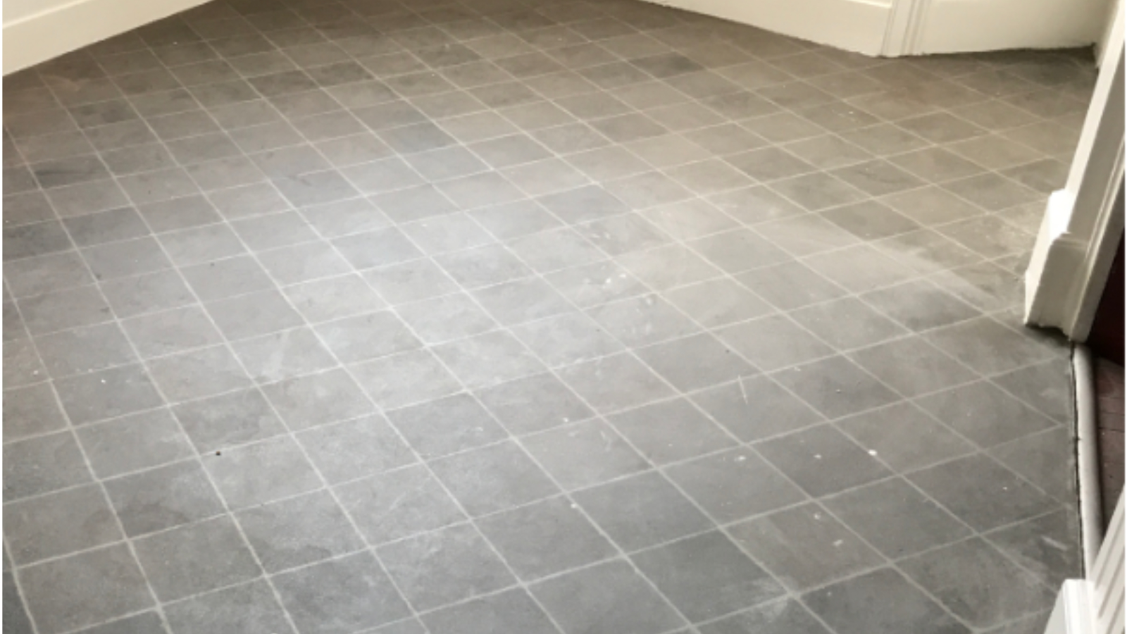 Vinyl kitchen floor in Sunderland with paint splashes and renovation residue before professional cleaning