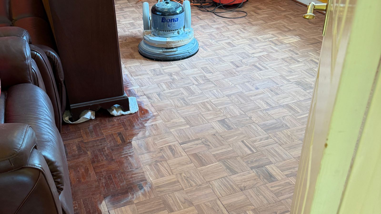 30-year-old finger parquet floor before sanding with heavy varnish and polish build-up