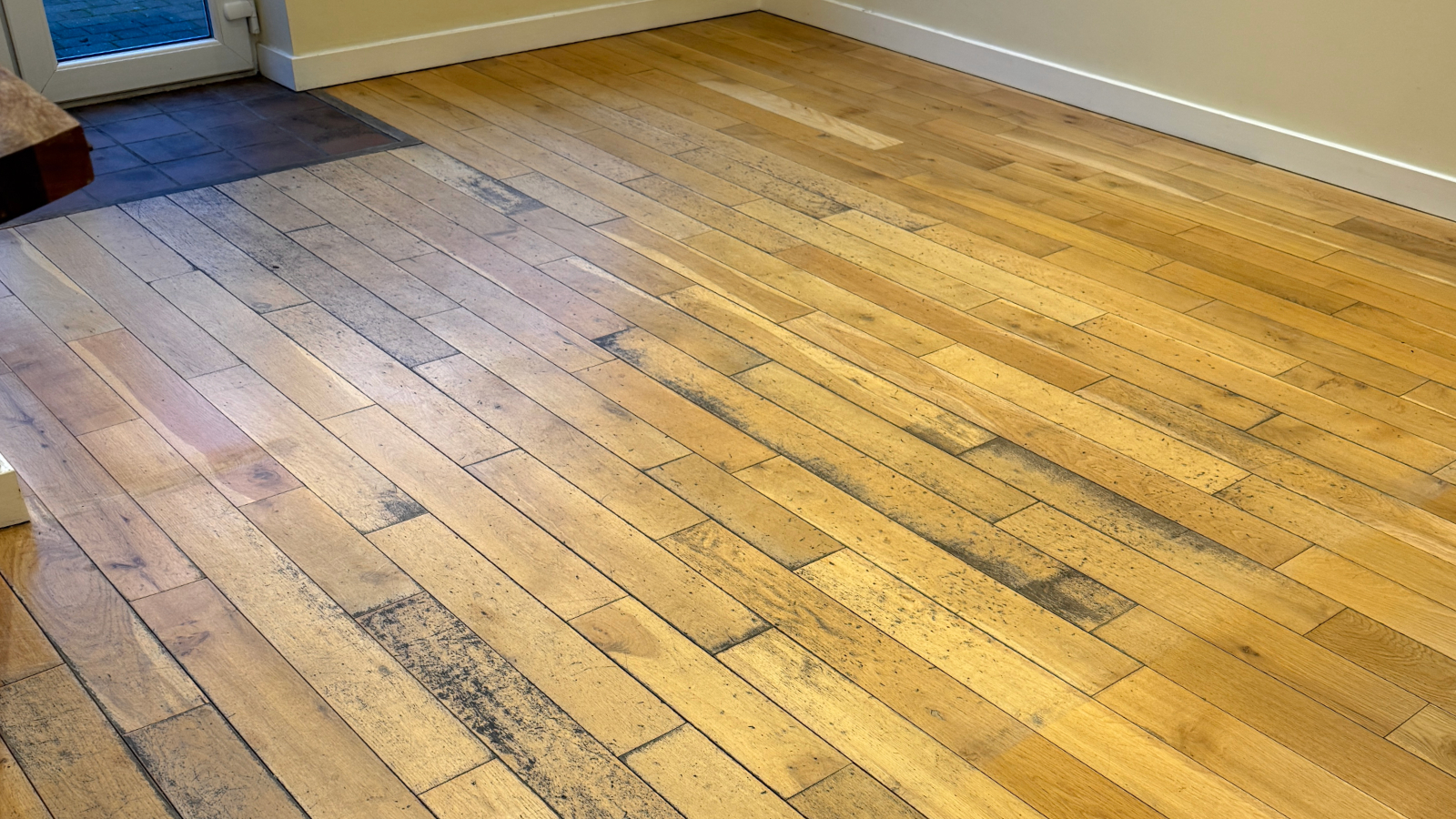 Worn oak flooring with dark traffic wear before sanding and restoration